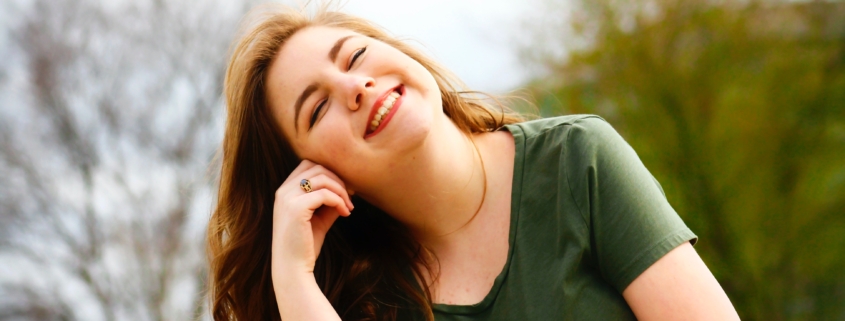 young, happy woman - what is aftercare in recovery